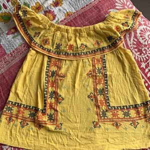 Yellow off the shoulder top with navy and red stitching